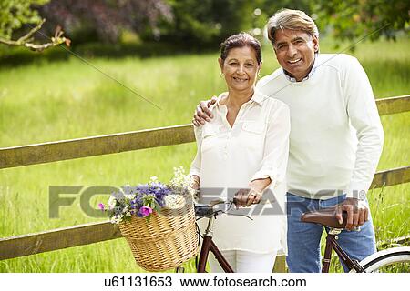 Senior Indian Couple On Cycle Ride In Countryside View Large Photo Image Stock Image - Senior Indian Couple On Cycle Ride In Countryside. Fotosearch