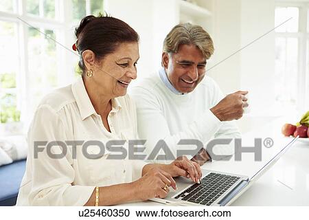 Senior Indian Couple Using Laptop At Home View Large Photo Image Stock Image - Senior Indian Couple Using Laptop At Home. Fotosearch