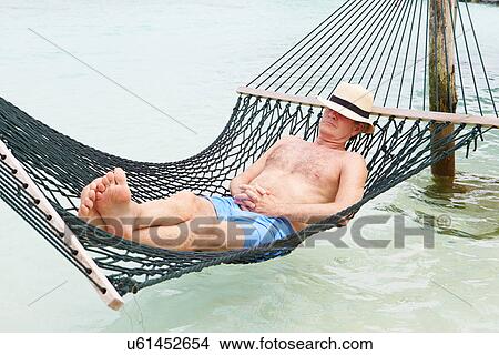 Picture - Senior Man Relaxing In Beach Hammock . Fotosearch