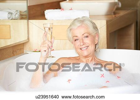 Senior Woman Relaxing In Bath Drinking Champagne View Large Photo Image Stock Image - Senior Woman Relaxing In Bath Drinking Champagne . Fotosearch