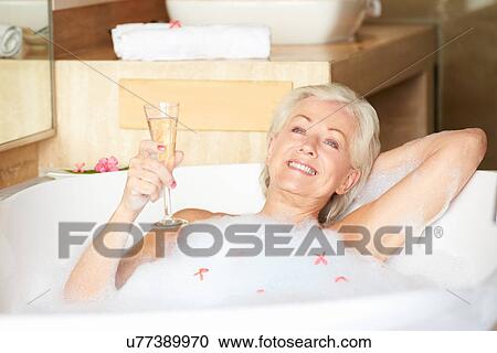 Senior Woman Relaxing In Bath Drinking Champagne View Large Photo Image Stock Image - Senior Woman Relaxing In Bath Drinking Champagne . Fotosearch
