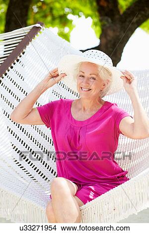 Picture - Senior Woman Relaxing In Beach Hammock. Fotosearch