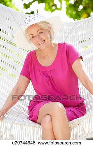 Senior Woman Relaxing In Beach Hammock View Large Photo Image Stock Photograph - Senior Woman Relaxing In Beach Hammock. Fotosearch