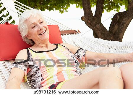 Senior Woman Relaxing In Beach Hammock View Large Photo Image Stock Photograph - Senior Woman Relaxing In Beach Hammock. Fotosearch