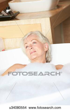 Picture - Senior Woman Relaxing In Bubble Bath . Fotosearch