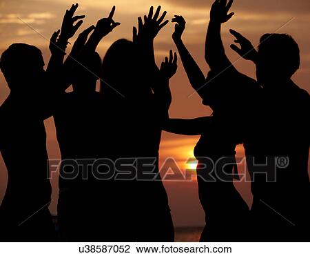 Stock Image - Silhouette Of Friends Having Beach Party. Fotosearch