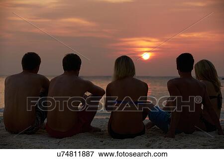 Silhouette Of Friends Sitting On Beach View Large Photo Image Stock Photo - Silhouette Of Friends Sitting On Beach. Fotosearch