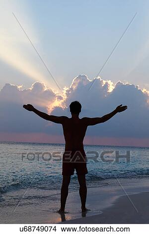 Silhouette Of Man With Outstretched Arms On Beach At Sunset View Large Photo Image Picture - Silhouette Of Man With Outstretched Arms On Beach At Sunset. Fotosearch