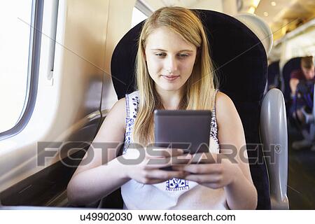 Teenage Girl Reading E Book On Train Journey View Large Photo Image Stock Image - Teenage Girl Reading E Book On Train Journey. Fotosearch