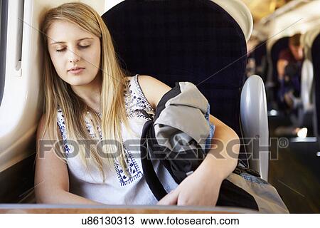 Stock Image - Teenage Girl Resting On Train Journey. Fotosearch