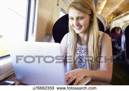 Teenage Girl Using Laptop On Train Journey View Large Photo Image Stock Photo - Teenage Girl Using Laptop On Train Journey. Fotosearch