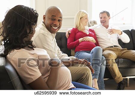 Stock Photo - Three Doctors Having Discussion Using Digital Tablet. Fotosearch