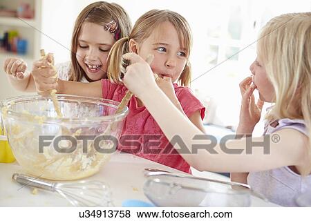 Three Girls Making Cupcakes In Kitchen View Large Photo Image Stock Photo - Three Girls Making Cupcakes In Kitchen. Fotosearch