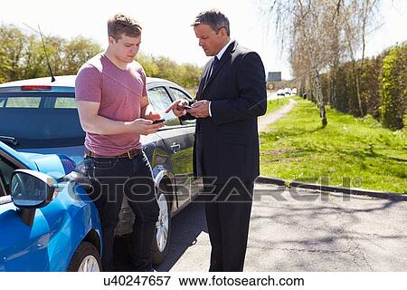 Stock Photo - Two Drivers Exchange Insurance Details After Accident. Fotosearch