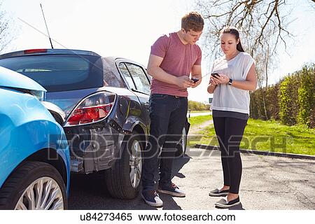 Stock Photography - Two Drivers Exchange Insurance Details After Accident. Fotosearch