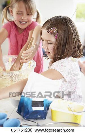Two Girls Making Cupcakes In Kitchen View Large Photo Image Stock Image - Two Girls Making Cupcakes In Kitchen. Fotosearch