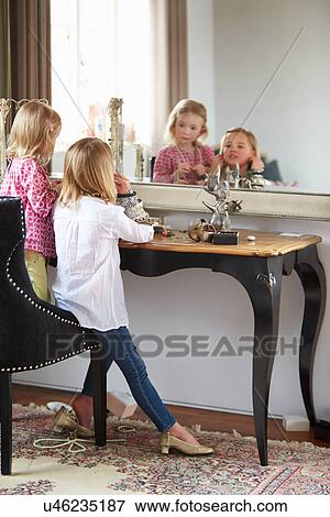 Stock Photo - Two Girls Playing With Jewelry And Make Up. Fotosearch