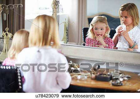 Stock Photo - Two Girls Playing With Jewelry And Make Up. Fotosearch
