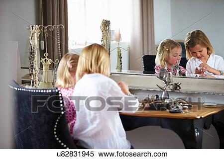 Stock Photography - Two Girls Playing With Jewelry And Make Up. Fotosearch