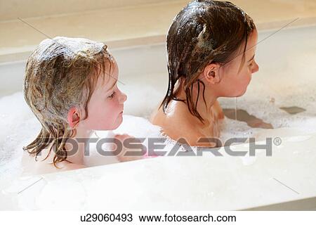 Stock Image - Two Girls Sharing Bubble Bath. Fotosearch