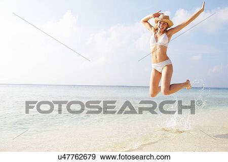 Woman Jumping In The Air On Tropical Beach View Large Photo Image Stock Photo - Woman Jumping In The Air On Tropical Beach. Fotosearch