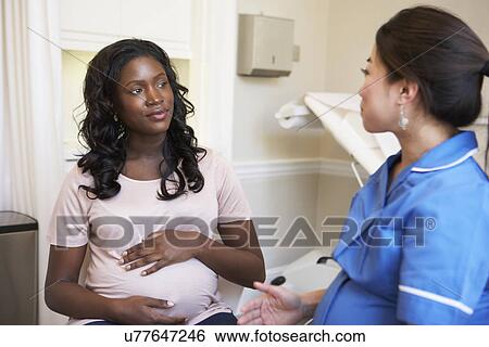 Stock Photograph - Woman Meeting With Obstetrician In Clinic. Fotosearch