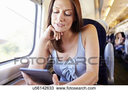 Woman Reading E Book On Train View Large Photo Image Stock Image - Woman Reading E Book On Train. Fotosearch