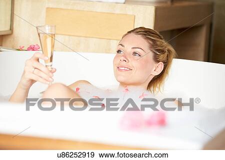 Woman Relaxing In Bath Drinking Champagne View Large Photo Image Stock Photo - Woman Relaxing In Bath Drinking Champagne . Fotosearch