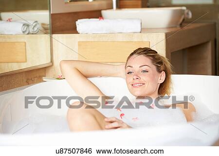 Stock Photograph - Woman Relaxing In Bubble Bath. Fotosearch