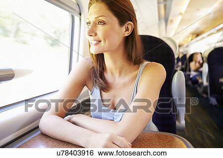 Stock Photograph - Woman Relaxing On Train Journey. Fotosearch