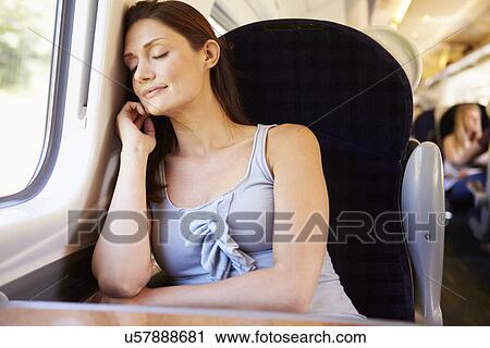 Stock Image - Woman Resting On Train Journey. Fotosearch