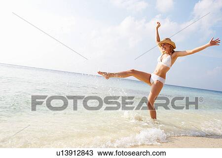 Woman Splashing In Sea On Beach Holiday View Large Photo Image Stock Image - Woman Splashing In Sea On Beach Holiday. Fotosearch