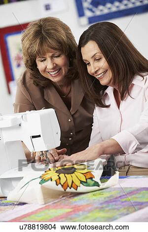 Picture - Woman Using Electric Sewing Machine. Fotosearch