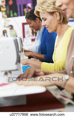 Woman Using Electric Sewing Machine View Large Photo Image Stock Photograph - Woman Using Electric Sewing Machine. Fotosearch