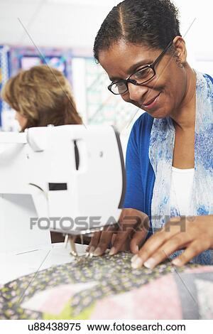 Woman Using Electric Sewing Machine View Large Photo Image Stock Photography - Woman Using Electric Sewing Machine. Fotosearch