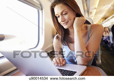 Woman Using Laptop On Train View Large Photo Image Picture - Woman Using Laptop On Train. Fotosearch