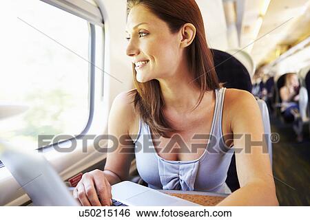 Woman Using Laptop On Train View Large Photo Image Stock Photograph - Woman Using Laptop On Train. Fotosearch