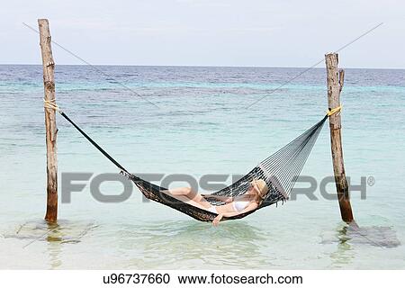 Woman Wearing Bikini And Sun Hat Relaxing In Beach Hammock View Large Photo Image Stock Image - Woman Wearing Bikini And Sun Hat Relaxing In Beach Hammock . Fotosearch