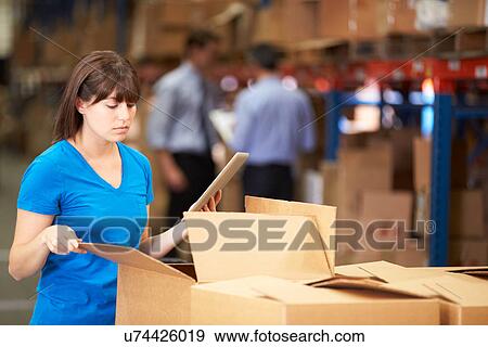 Worker In Warehouse Checking Boxes Using Digital Tablet View Large Photo Image Stock Photo - Worker In Warehouse Checking Boxes Using Digital Tablet. Fotosearch