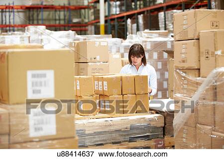 Worker In Warehouse Preparing Goods For Dispatch View Large Photo Image Stock Photo - Worker In Warehouse Preparing Goods For Dispatch. Fotosearch