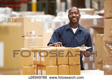 Worker In Warehouse Preparing Goods For Dispatch View Large Photo Image Stock Photograph - Worker In Warehouse Preparing Goods For Dispatch. Fotosearch