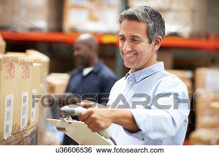 Worker Scanning Package In Warehouse View Large Photo Image Stock Photograph - Worker Scanning Package In Warehouse. Fotosearch