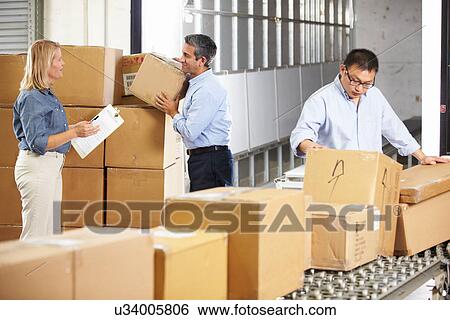 Workers Checking Goods On Belt In Distribution Warehouse View Large Photo Image Stock Photograph - Workers Checking Goods On Belt In Distribution Warehouse. Fotosearch
