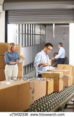Workers Checking Goods On Belt In Distribution Warehouse View Large Photo Image Stock Photograph - Workers Checking Goods On Belt In Distribution Warehouse. Fotosearch