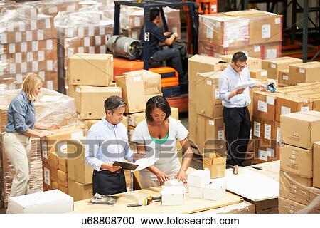 Workers In Warehouse Preparing Goods For Dispatch View Large Photo Image Stock Image - Workers In Warehouse Preparing Goods For Dispatch. Fotosearch