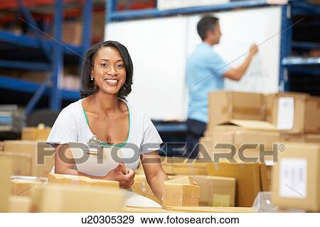 Workers In Warehouse Preparing Goods For Dispatch View Large Photo Image Stock Photo - Workers In Warehouse Preparing Goods For Dispatch. Fotosearch