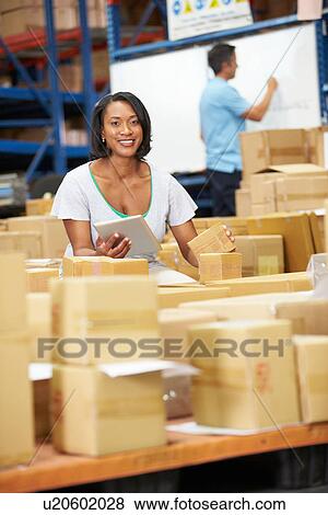 Workers In Warehouse Preparing Goods For Dispatch View Large Photo Image Stock Photo - Workers In Warehouse Preparing Goods For Dispatch. Fotosearch