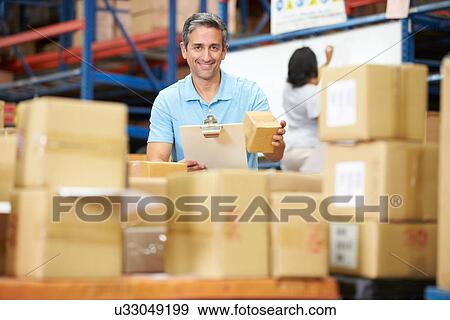 Workers In Warehouse Preparing Goods For Dispatch View Large Photo Image Stock Photo - Workers In Warehouse Preparing Goods For Dispatch. Fotosearch