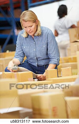 Workers In Warehouse Preparing Goods For Dispatch View Large Photo Image Stock Photo - Workers In Warehouse Preparing Goods For Dispatch. Fotosearch