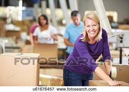 Workers In Warehouse Preparing Goods For Dispatch View Large Photo Image Stock Photo - Workers In Warehouse Preparing Goods For Dispatch. Fotosearch